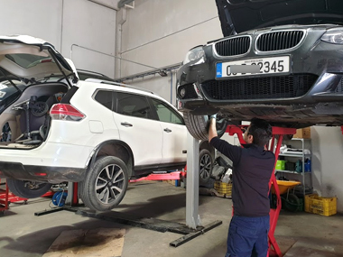 BMW 320i Cabrio at our workshop having suspension checked BMW 320i on workshop ramp